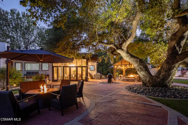 a view of a house with swimming pool and porch with furniture