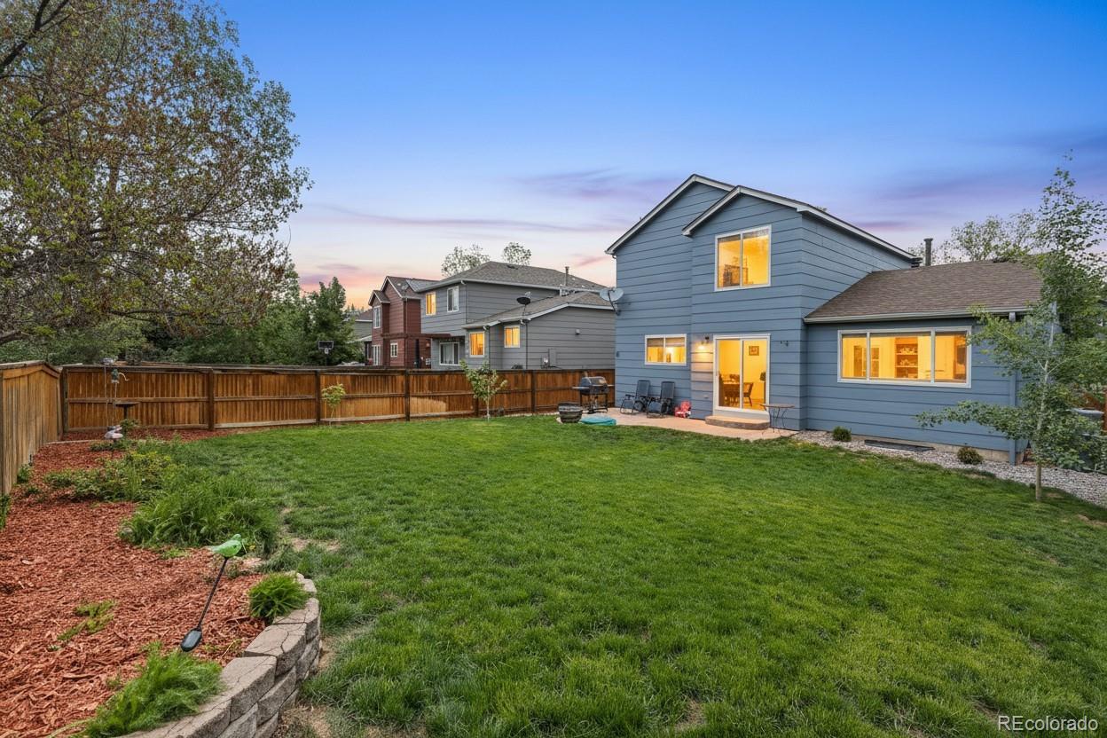 10565 Hyacinth Place Highlands Ranch, CO 80129 - Photo 28 of 33 a front view of a house with a yard