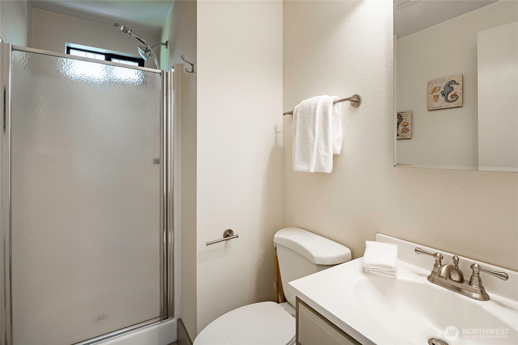 5537 Salish Road Blaine, WA 98230 - Photo 13 of 39 a bathroom with a sink mirror and toilet