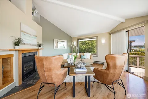 a dining room with furniture a window and wooden floor