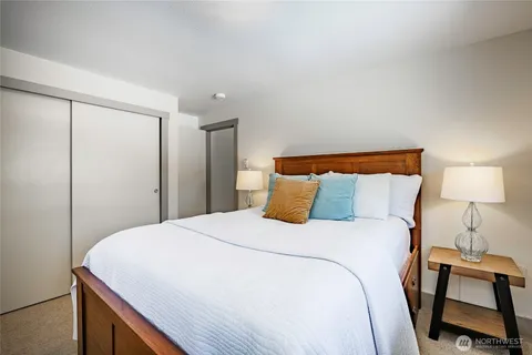 a bedroom with a bed and a lamp