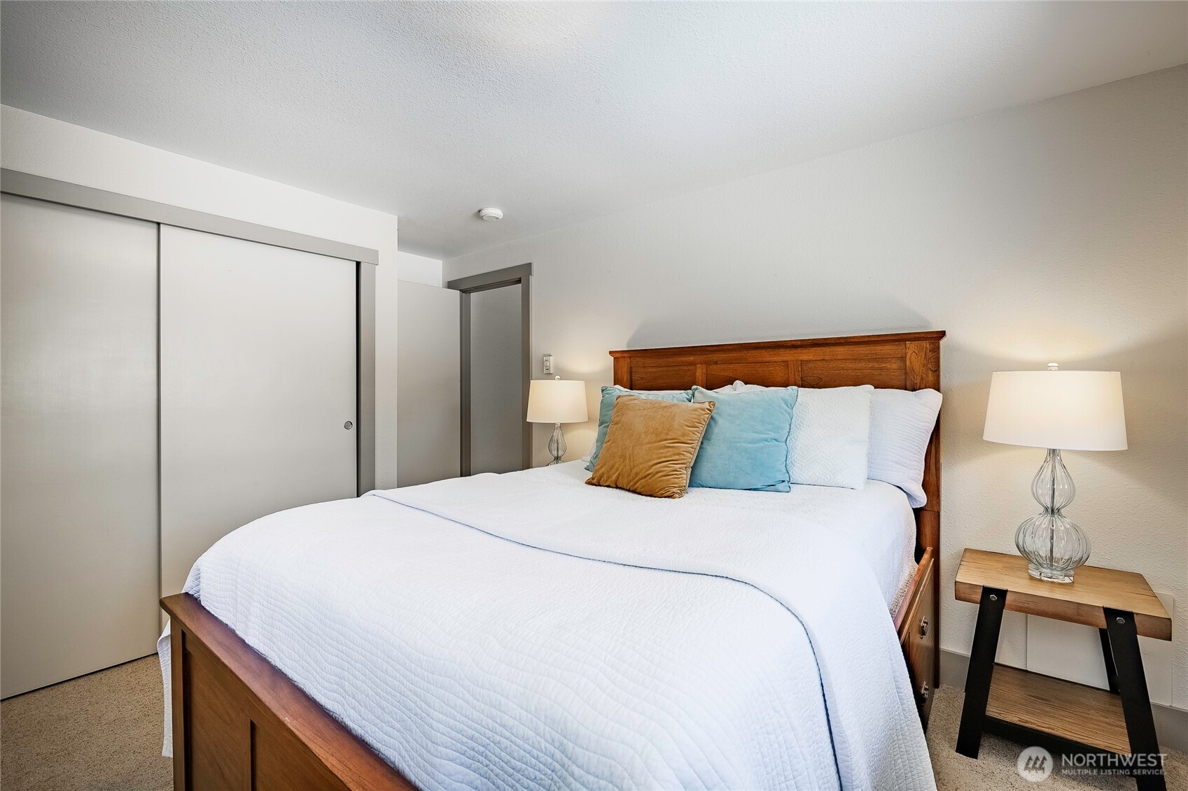 5537 Salish Road Blaine, WA 98230 - Photo 10 of 39 a bedroom with a bed and a lamp