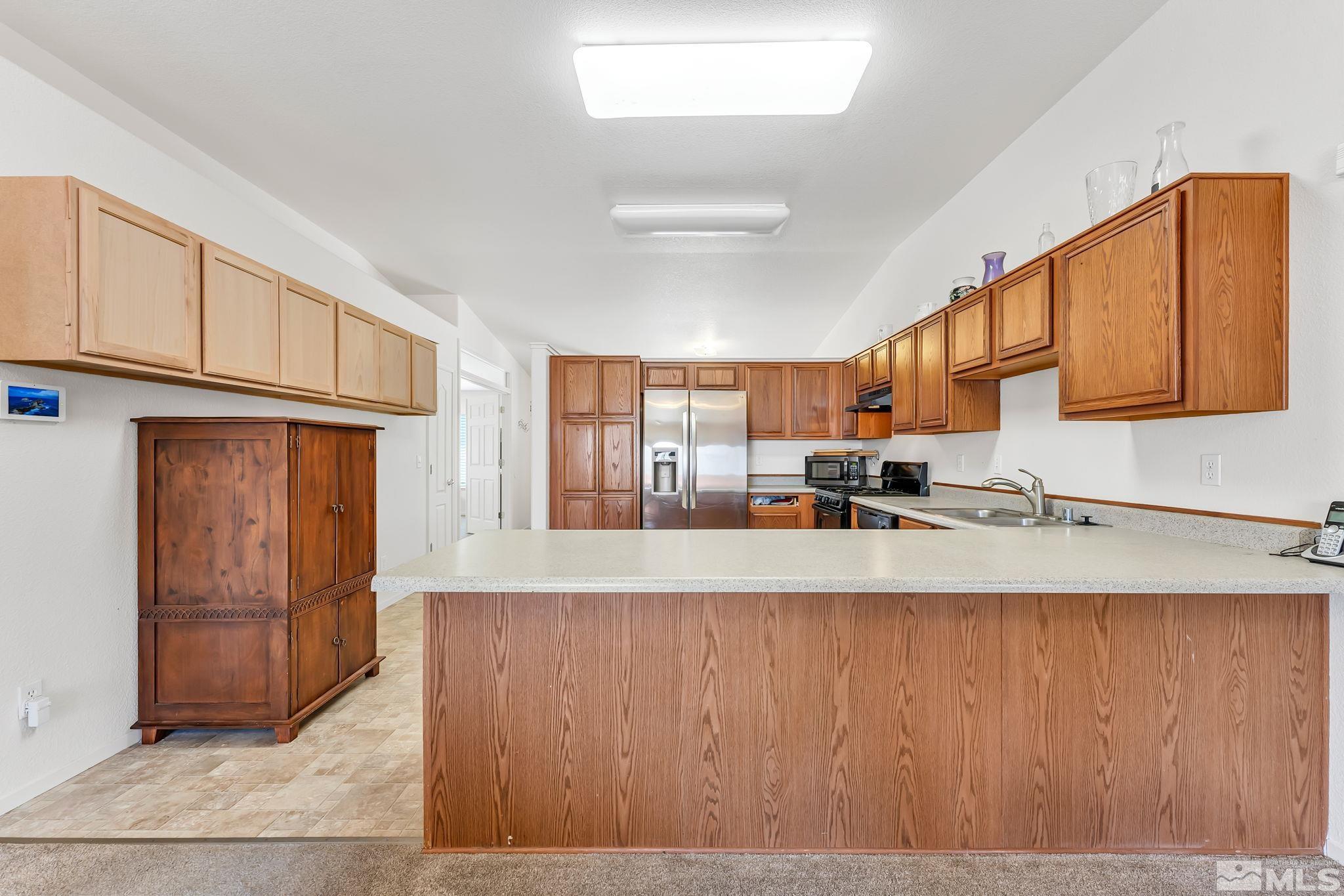 17541 Desert Lake Drive Reno, NV 89508 - Photo 11 of 33 a large white kitchen with wooden floors