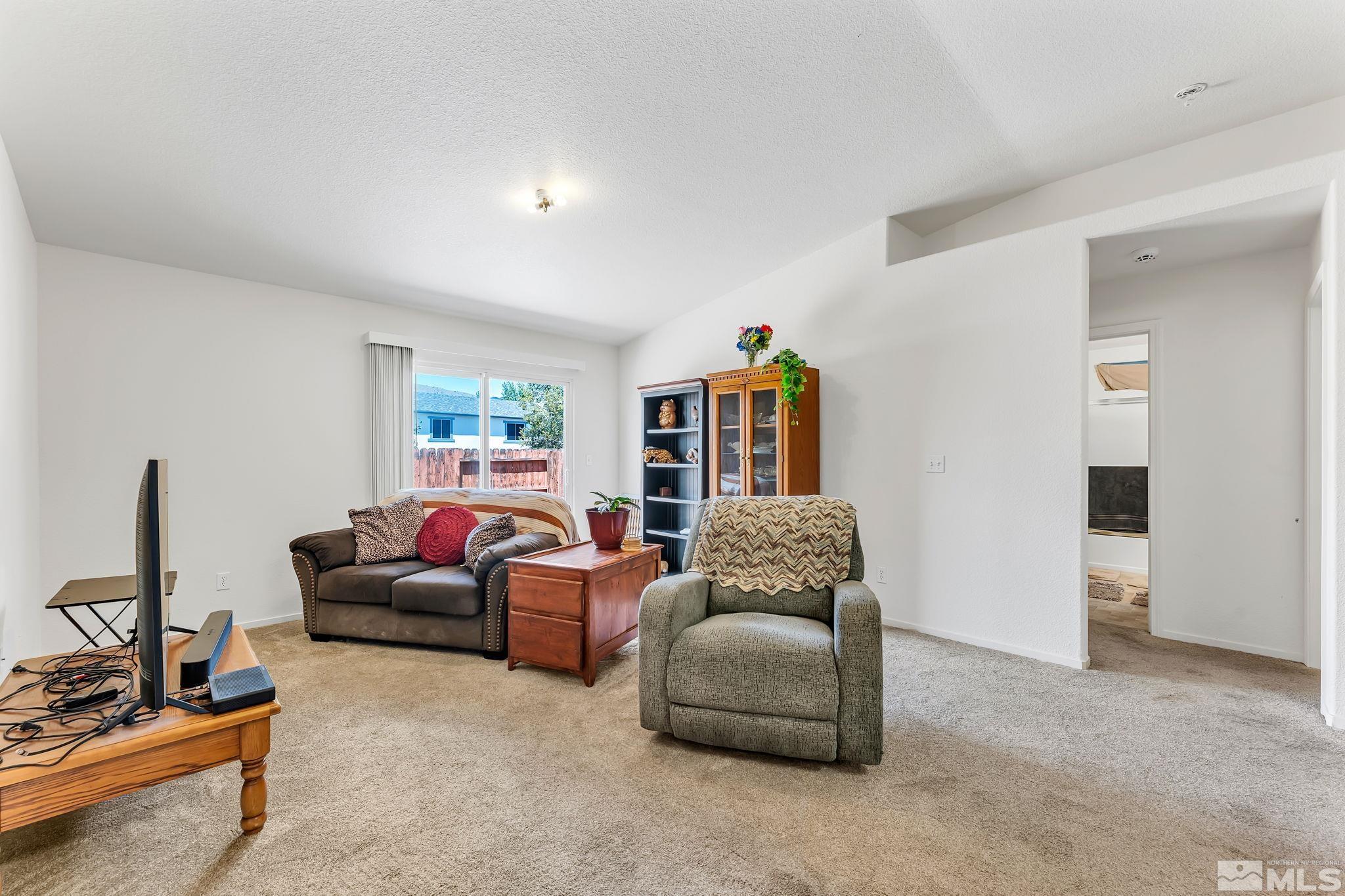 17541 Desert Lake Drive Reno, NV 89508 - Photo 13 of 33 a living room with furniture and a flat screen tv