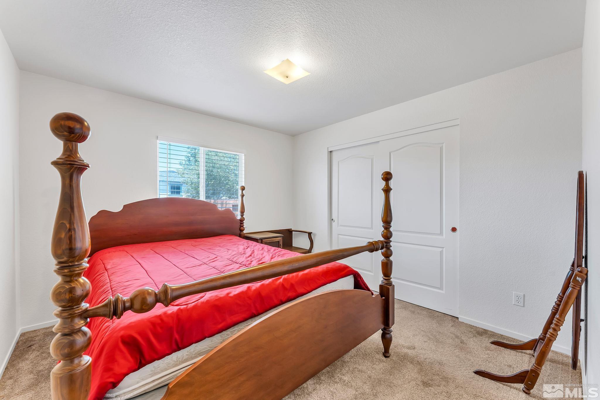 17541 Desert Lake Drive Reno, NV 89508 - Photo 20 of 33 a bedroom with a bed and a chandelier