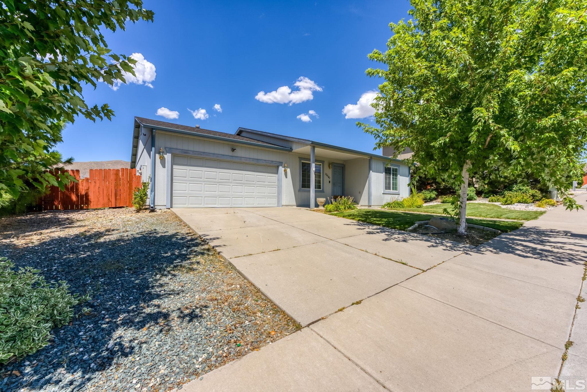 17541 Desert Lake Drive Reno, NV 89508 - Photo 2 of 33 a front view of a house with a yard and garage