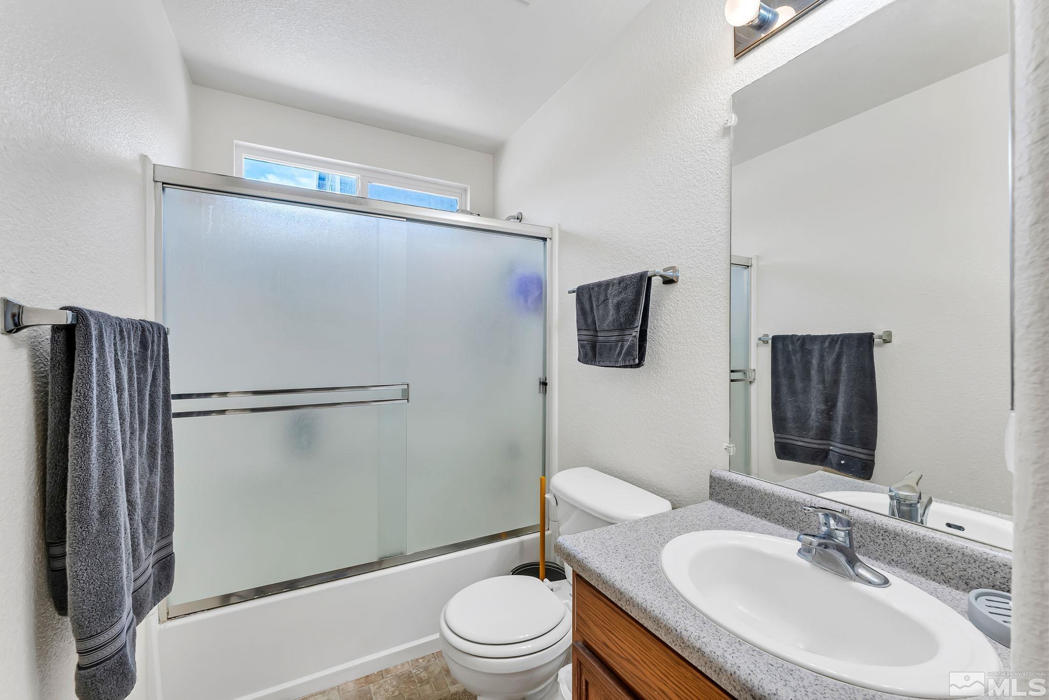 17541 Desert Lake Drive Reno, NV 89508 - Photo 21 of 33 a bathroom with a sink toilet and shower