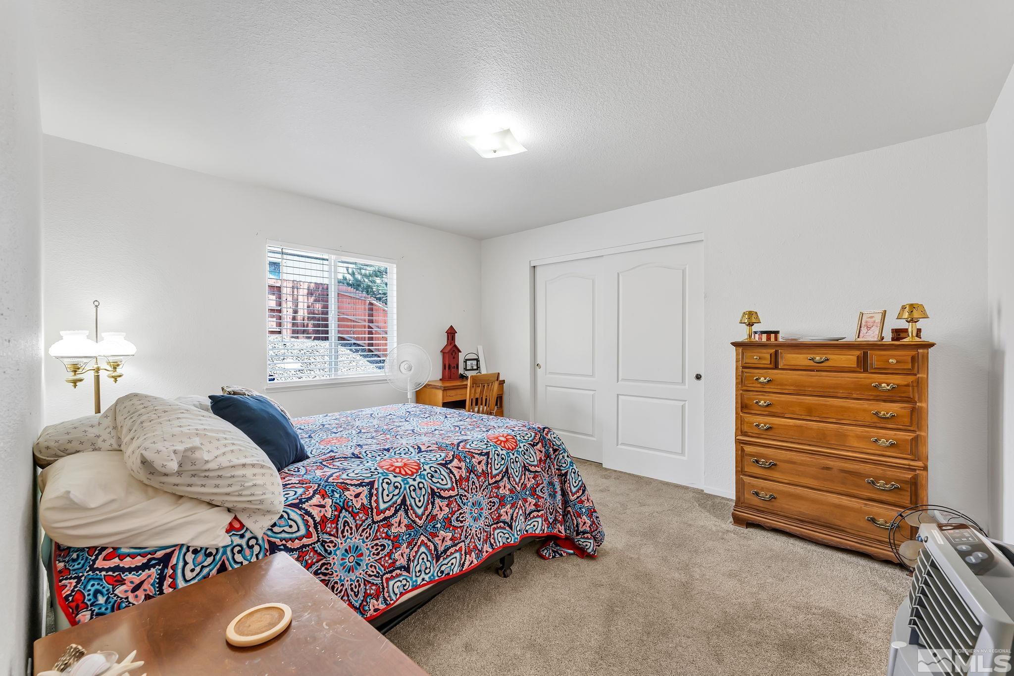 17541 Desert Lake Drive Reno, NV 89508 - Photo 22 of 33 a bedroom with a bed and cabinets