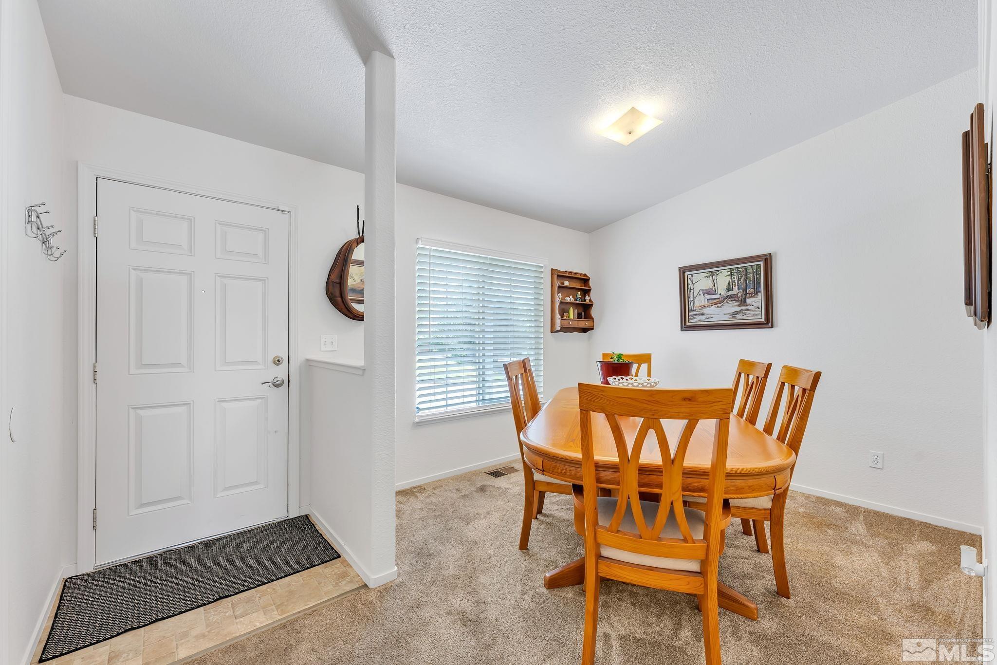 17541 Desert Lake Drive Reno, NV 89508 - Photo 4 of 33 a dining room with furniture and wooden floor