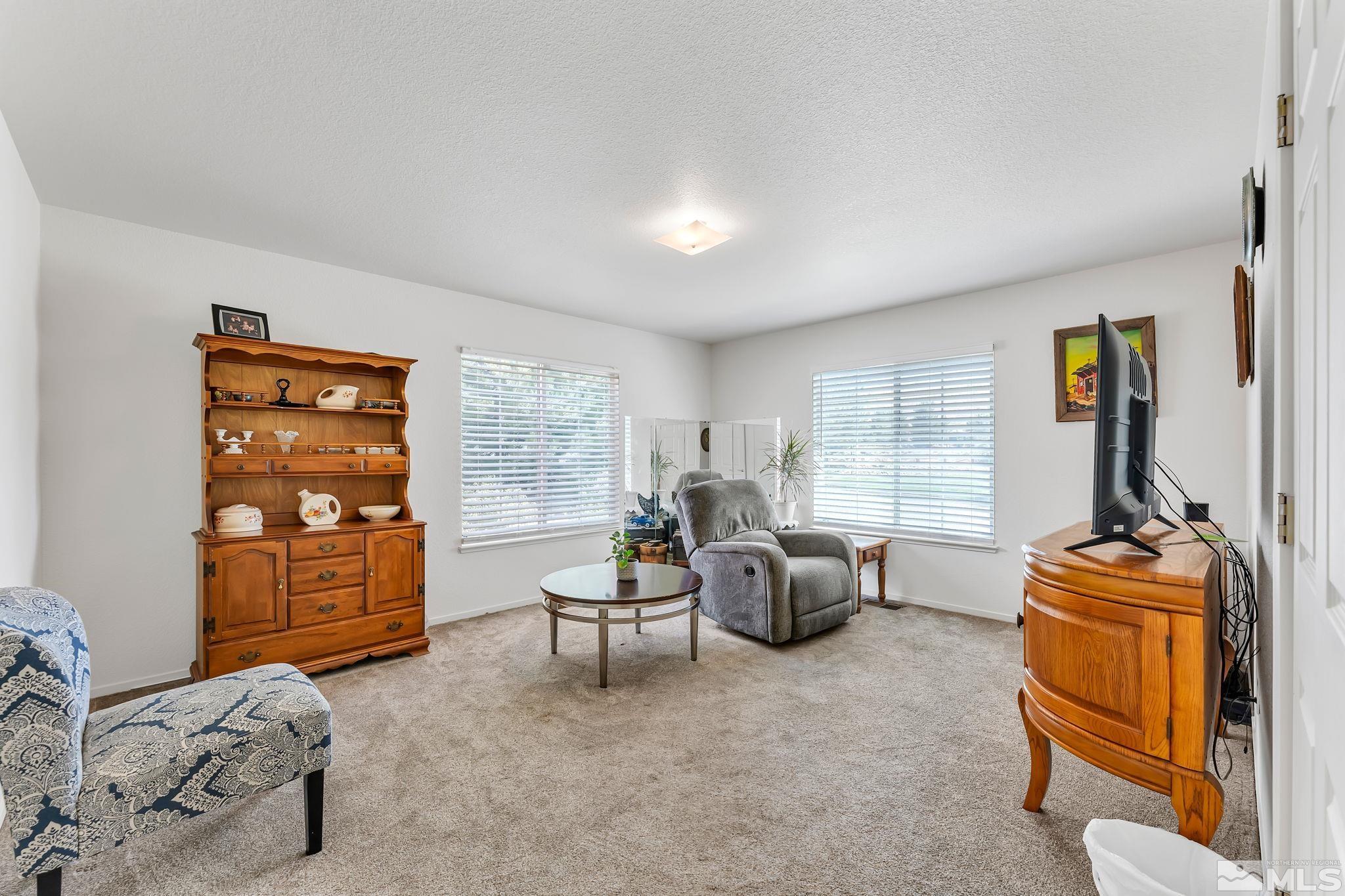 17541 Desert Lake Drive Reno, NV 89508 - Photo 6 of 33 a living room with furniture and a window