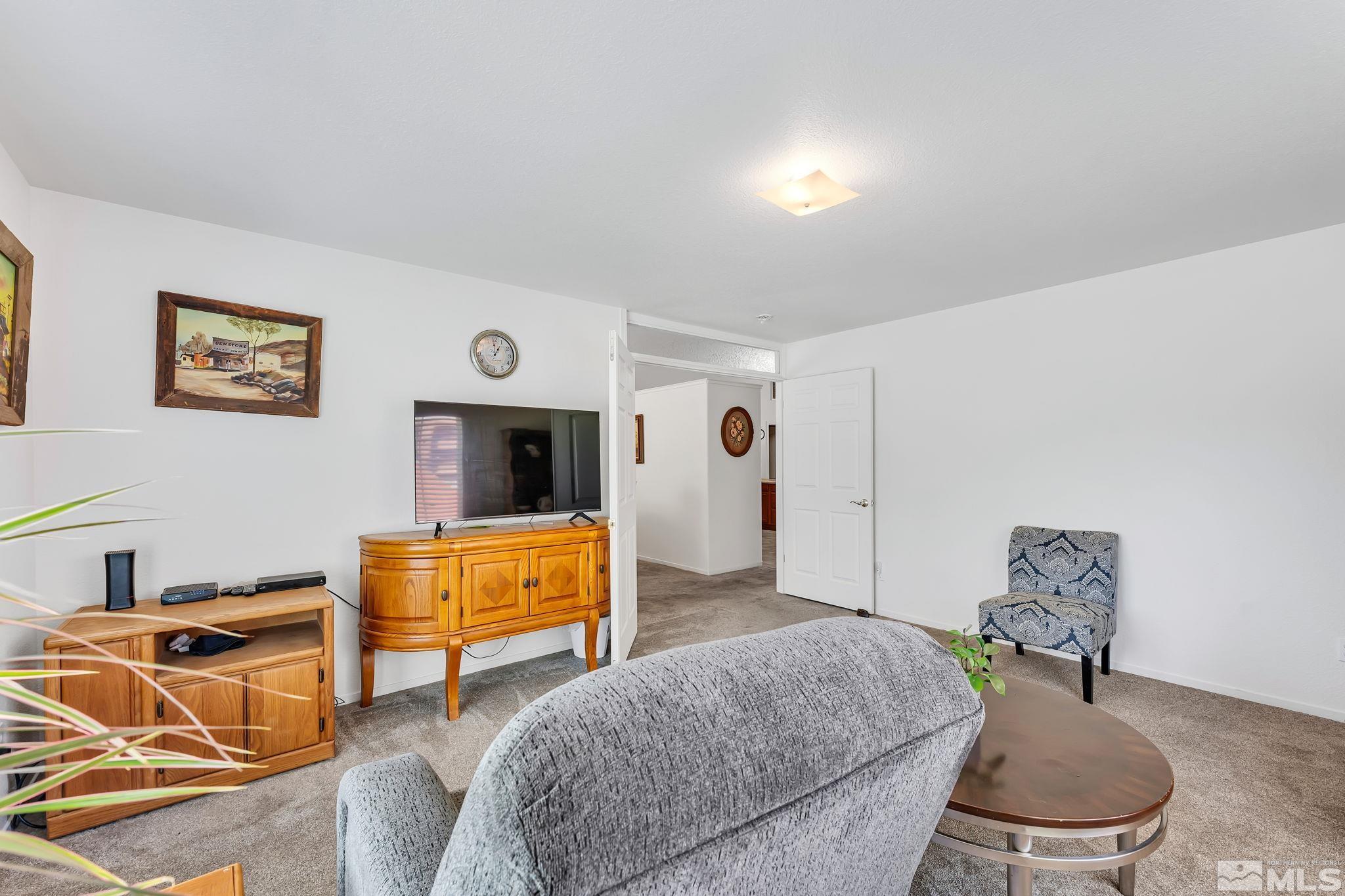 17541 Desert Lake Drive Reno, NV 89508 - Photo 7 of 33 a living room with furniture and a flat screen tv