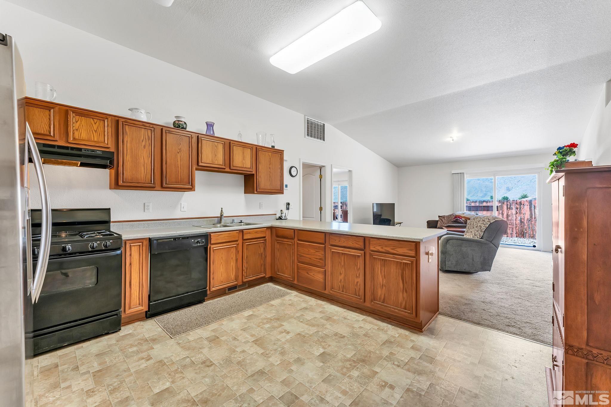 17541 Desert Lake Drive Reno, NV 89508 - Photo 8 of 33 a kitchen with stainless steel appliances granite countertop a stove sink and cabinets