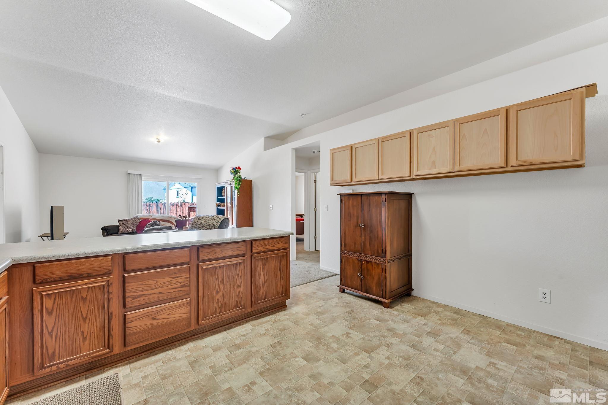 17541 Desert Lake Drive Reno, NV 89508 - Photo 9 of 33 a kitchen with stainless steel appliances granite countertop a refrigerator and cabinets