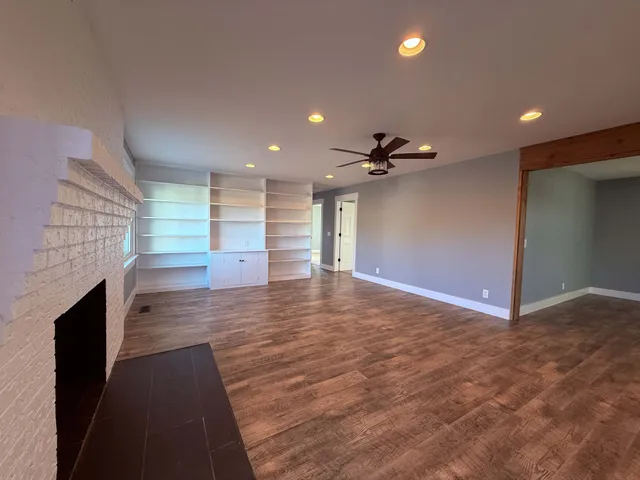 a large kitchen with kitchen island a large counter top space and stainless steel appliances