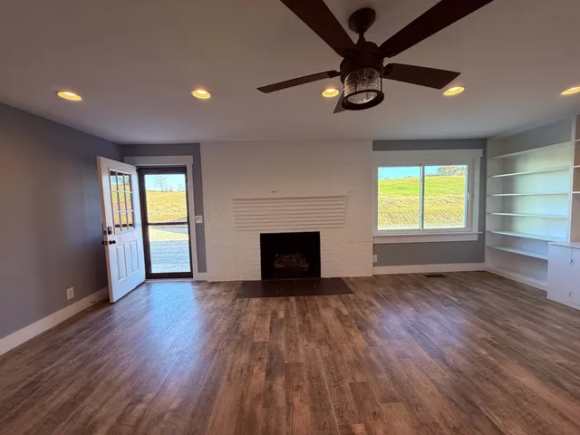 an empty room with windows and closet