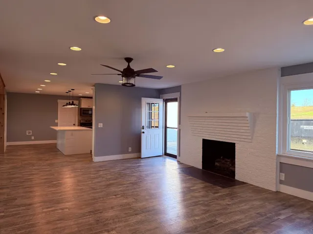 a bathroom with a granite countertop sink mirror and a bathtub