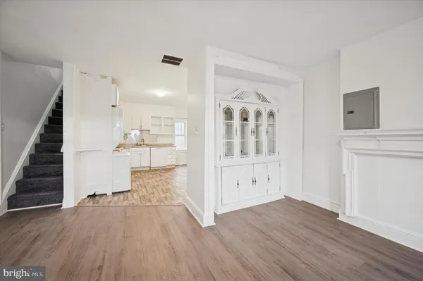 wooden floor with white walls and windows