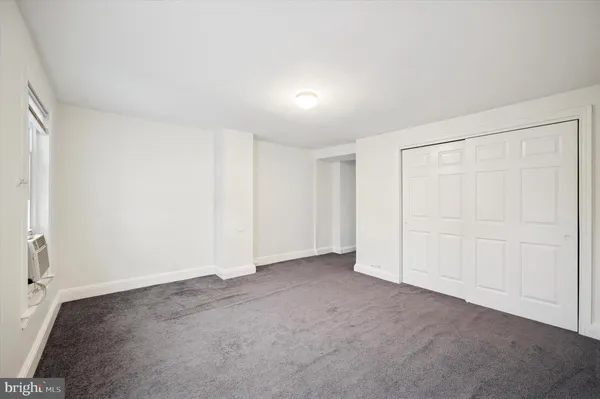 an empty room with a empty space and windows