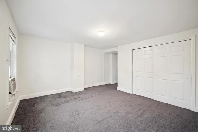 an empty room with a empty space and windows