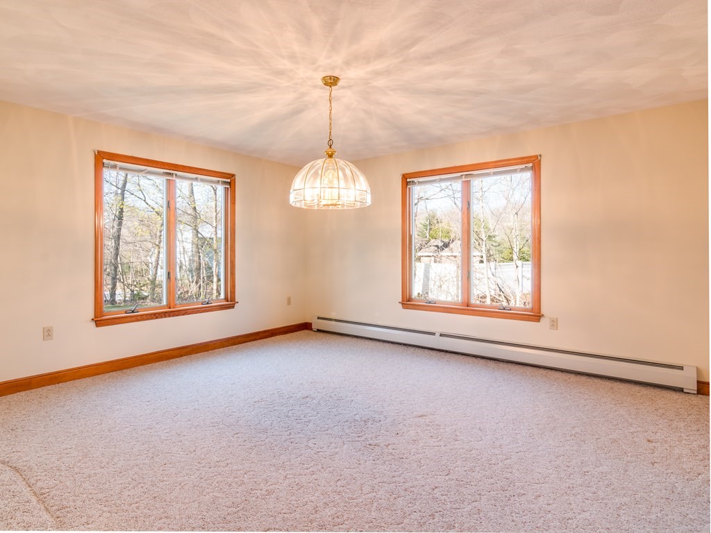 7 Old Town Road Beverly, MA 01915 - Photo 11 of 35 an empty room with windows and chandelier fan