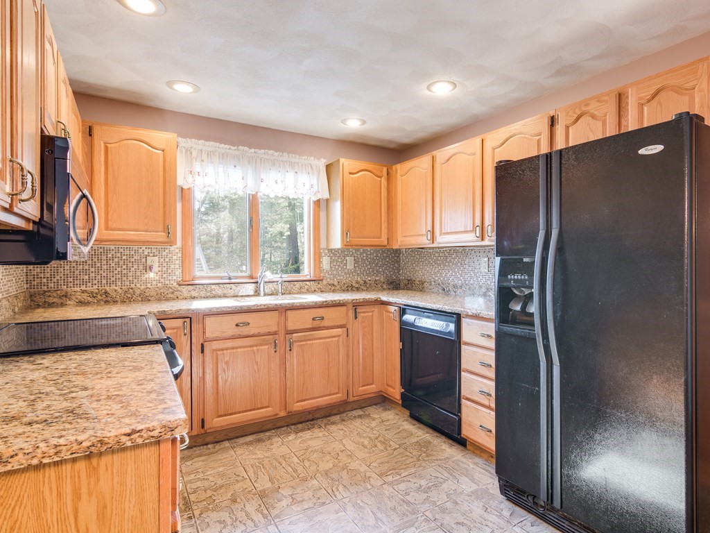 7 Old Town Road Beverly, MA 01915 - Photo 20 of 35 a kitchen with stainless steel appliances granite countertop a refrigerator and a sink