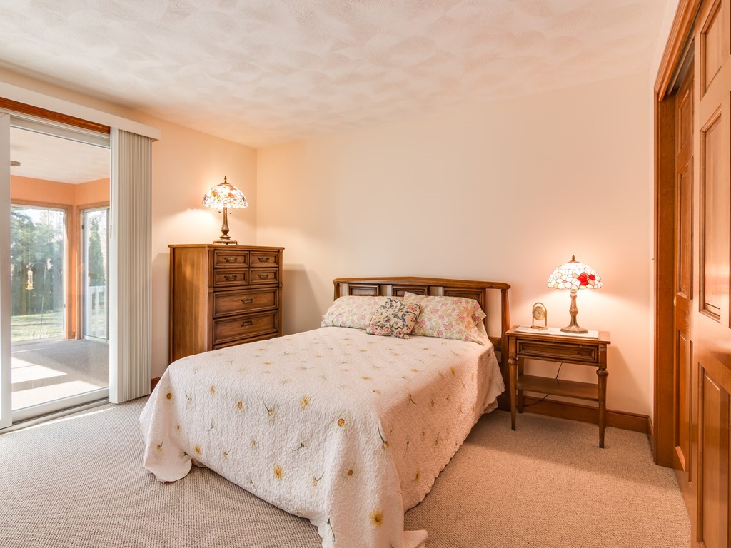 7 Old Town Road Beverly, MA 01915 - Photo 21 of 35 a bedroom with a bed and a chandelier