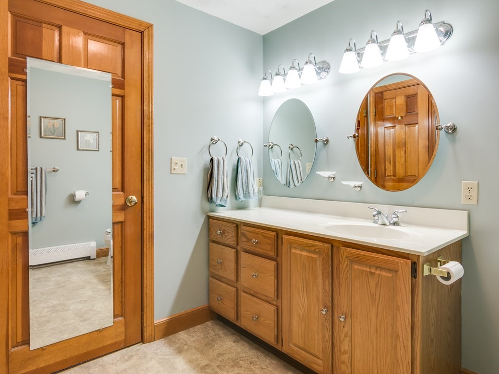 7 Old Town Road Beverly, MA 01915 - Photo 24 of 35 a bathroom with a double vanity sink and a mirror