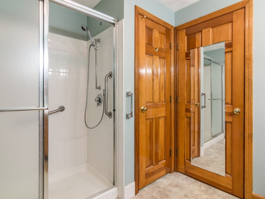 7 Old Town Road Beverly, MA 01915 - Photo 25 of 35 a bathroom with a glass shower door and a mirror