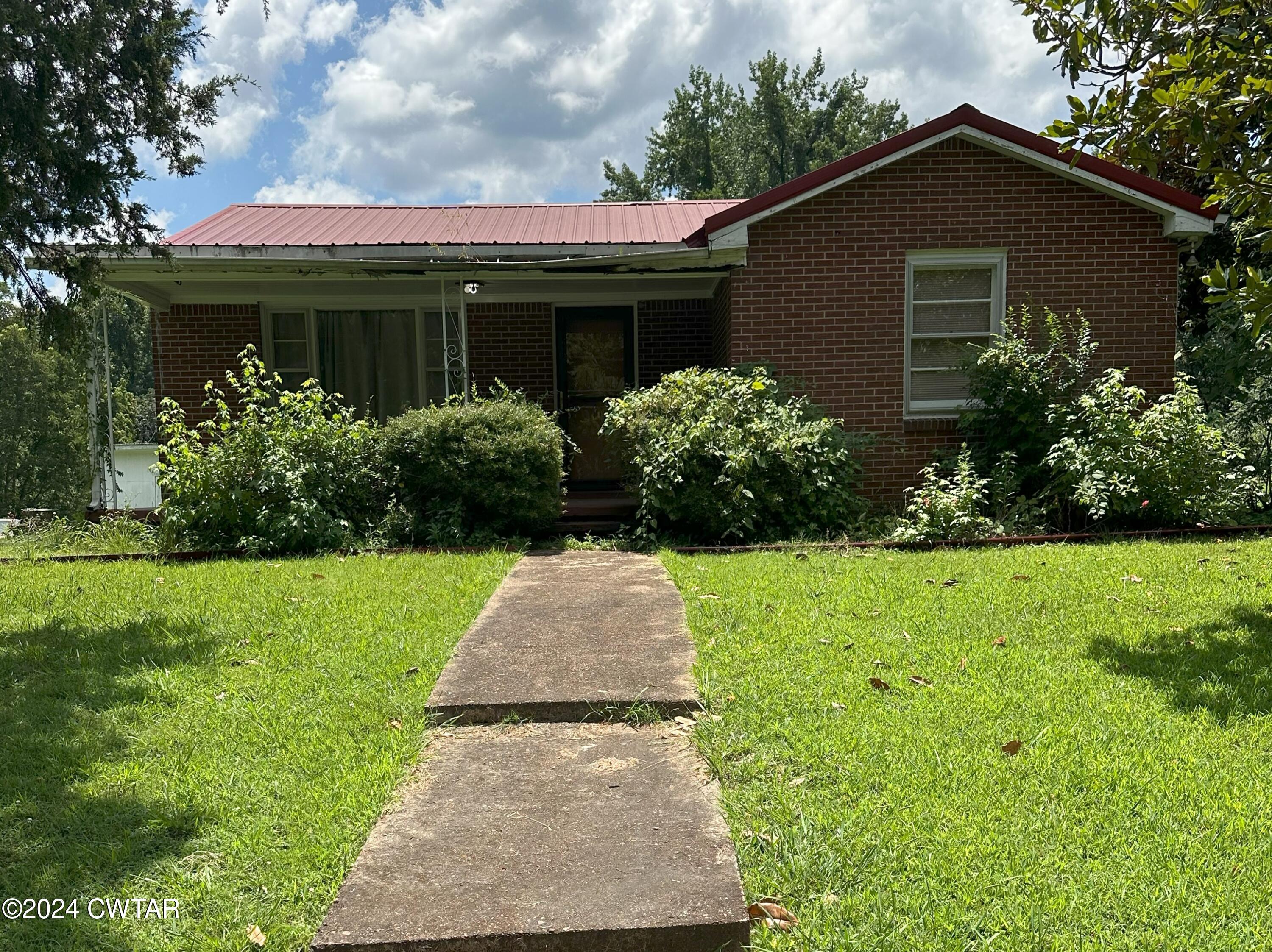 a front view of house with garden