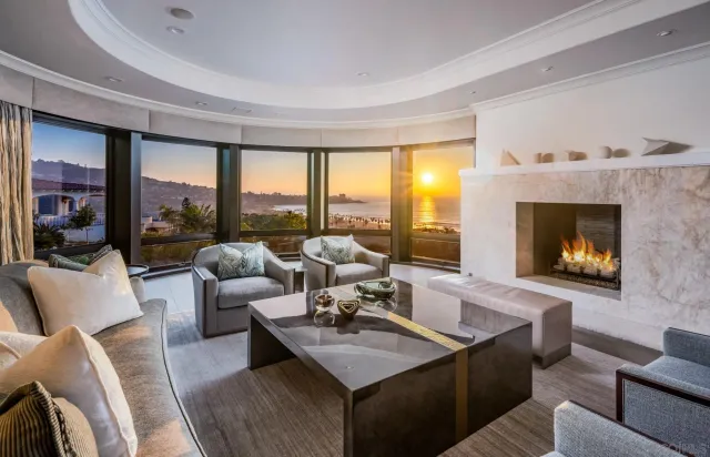 a living room with furniture flat screen tv and a large window