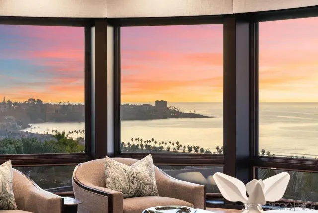 a balcony with furniture and a floor to ceiling window