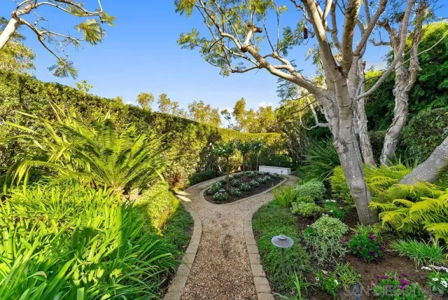 a bedroom with a bed and a flat tv screen on dresser