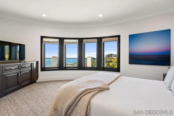 a spacious bedroom with a bed and a couch
