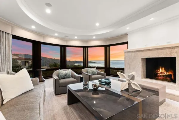 a living room with fireplace furniture and a large window