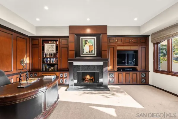 a living room with furniture and large windows