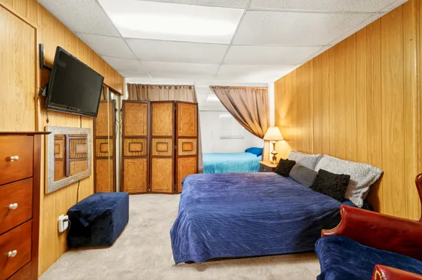 a bedroom with a bed window and couch