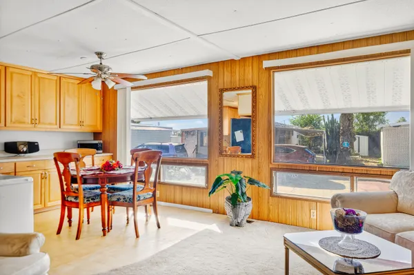 a dining room with furniture a chandelier and a rug