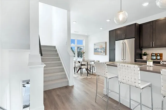 a view of a kitchen with dining table and chairs