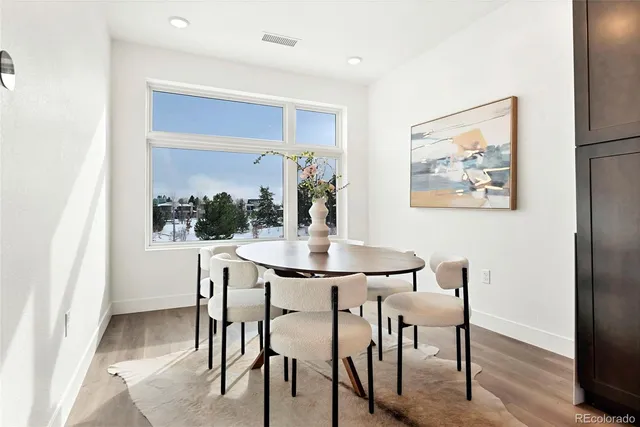 a view of a dining room with furniture and window