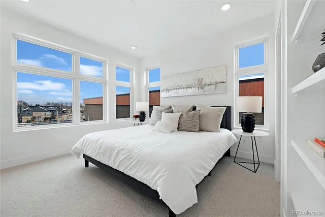 a bedroom with a large bed and a window