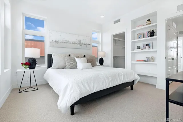 a bedroom with a bed and a potted plant