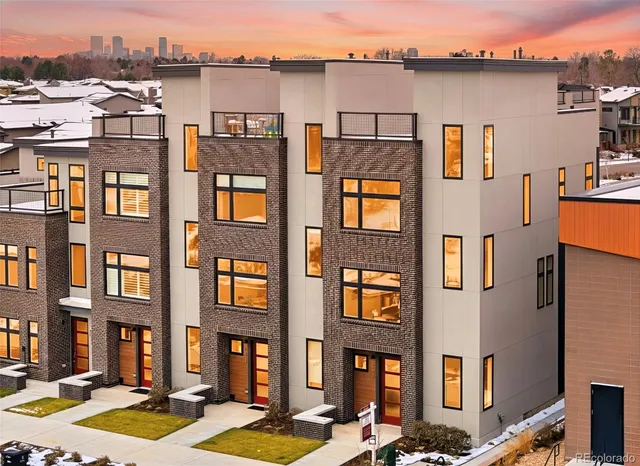 a front view of a residential apartment building with a yard