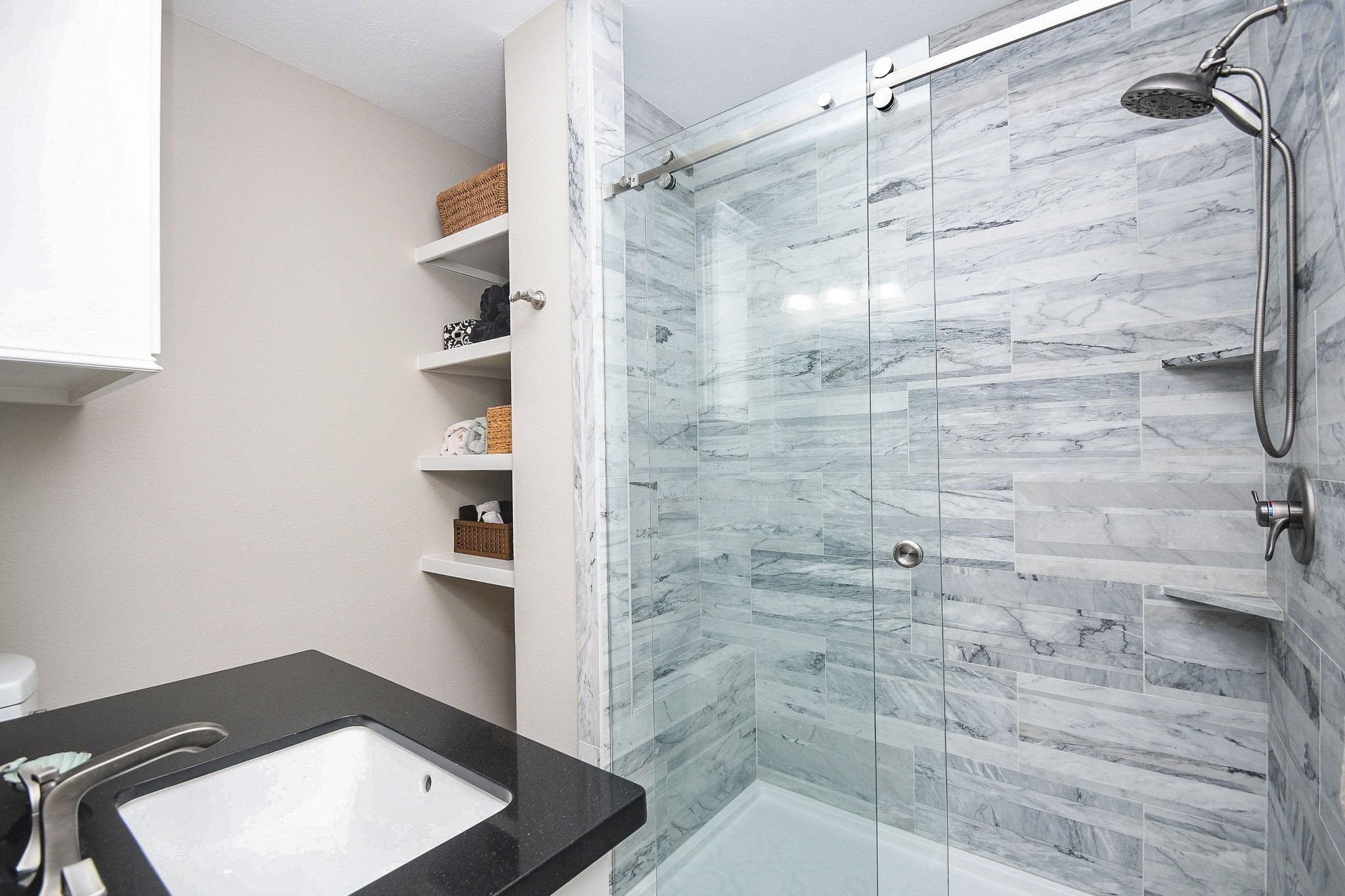 500 River Road, Unit 101 Montgomery, TX 77356 - Photo 9 of 27 Primary bath with shower bench and lots of storage shelves