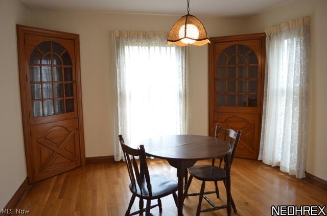 Formal dining room with wood floors, dual built ins and floor to ceiling windows.