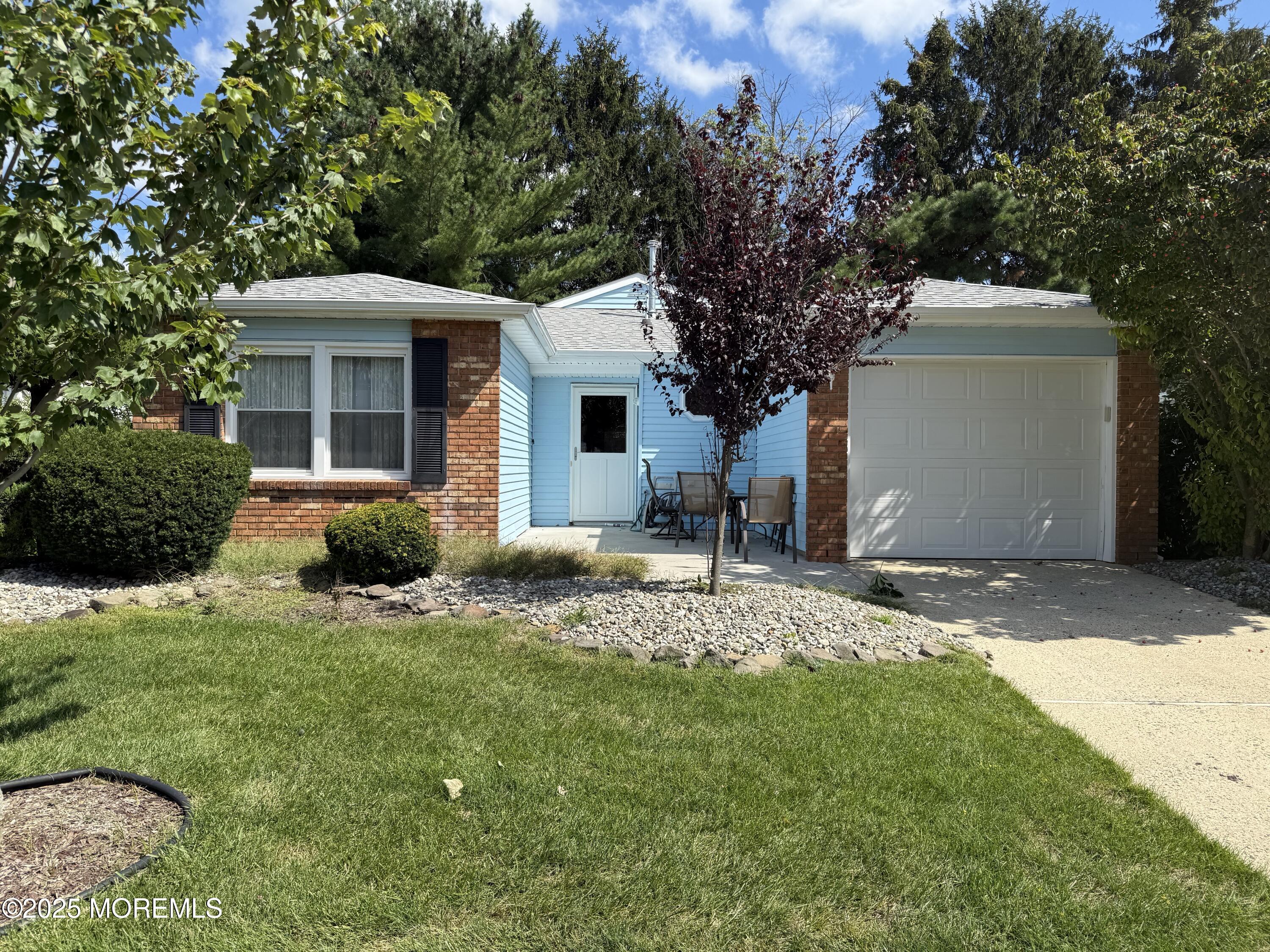 a front view of house with yard and trees