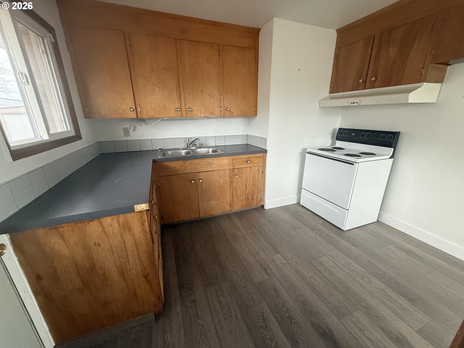805 Southeast 6th Street Pendleton, OR 97801 - Photo 14 of 32 a kitchen with wooden floors and a stove