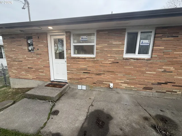 a front view of a house with parking space