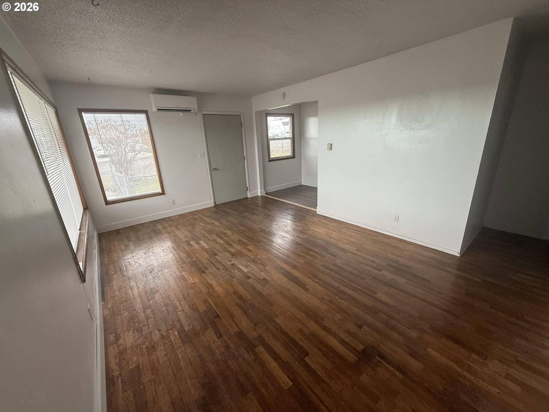 805 Southeast 6th Street Pendleton, OR 97801 - Photo 9 of 32 an empty room with wooden floor and windows