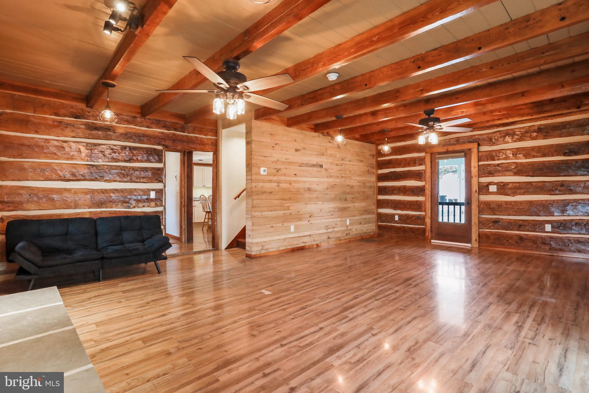 12354 Back Road Toms Brook, VA 22660 - Photo 8 of 58 Living room with exposed beams & log walls