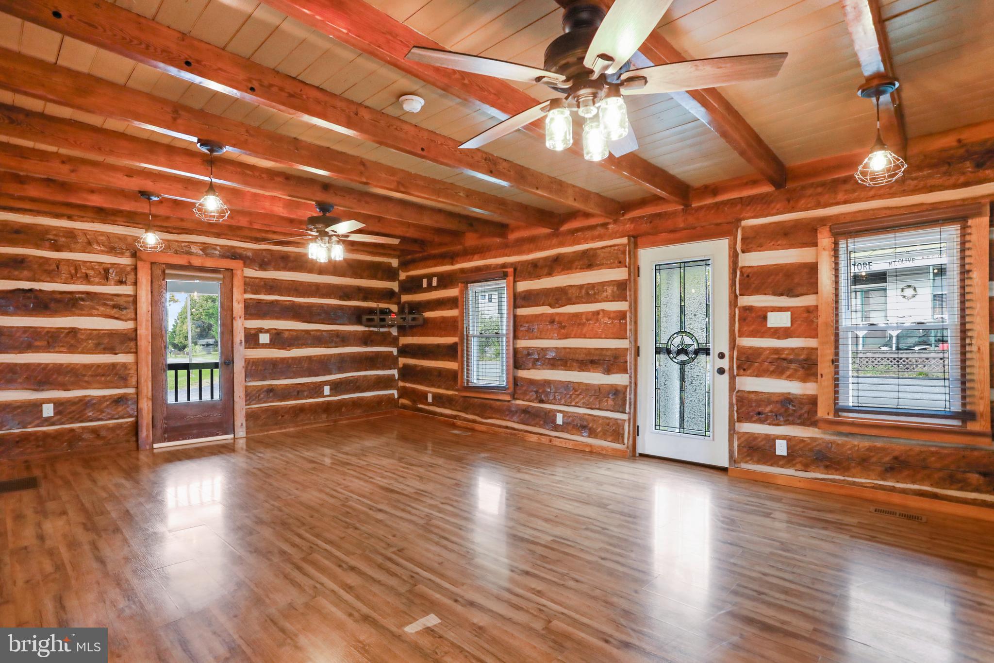 12354 Back Road Toms Brook, VA 22660 - Photo 9 of 58 Living room with exposed beams & log walls